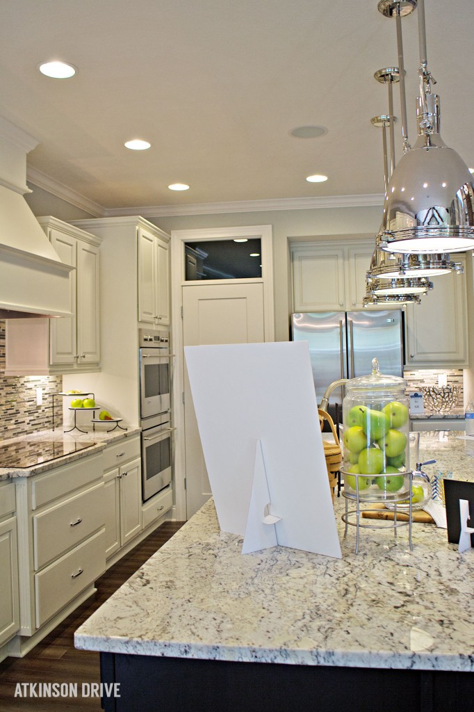 Home-a-Rama 2014: White kitchen with dark island and marble counters | Atkinson Drive